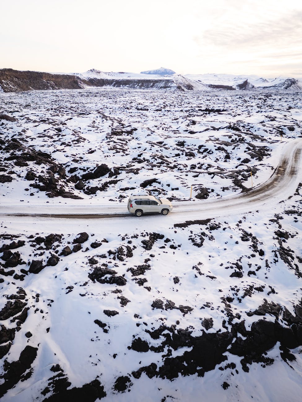 suv driving car in winter landscape on iceland